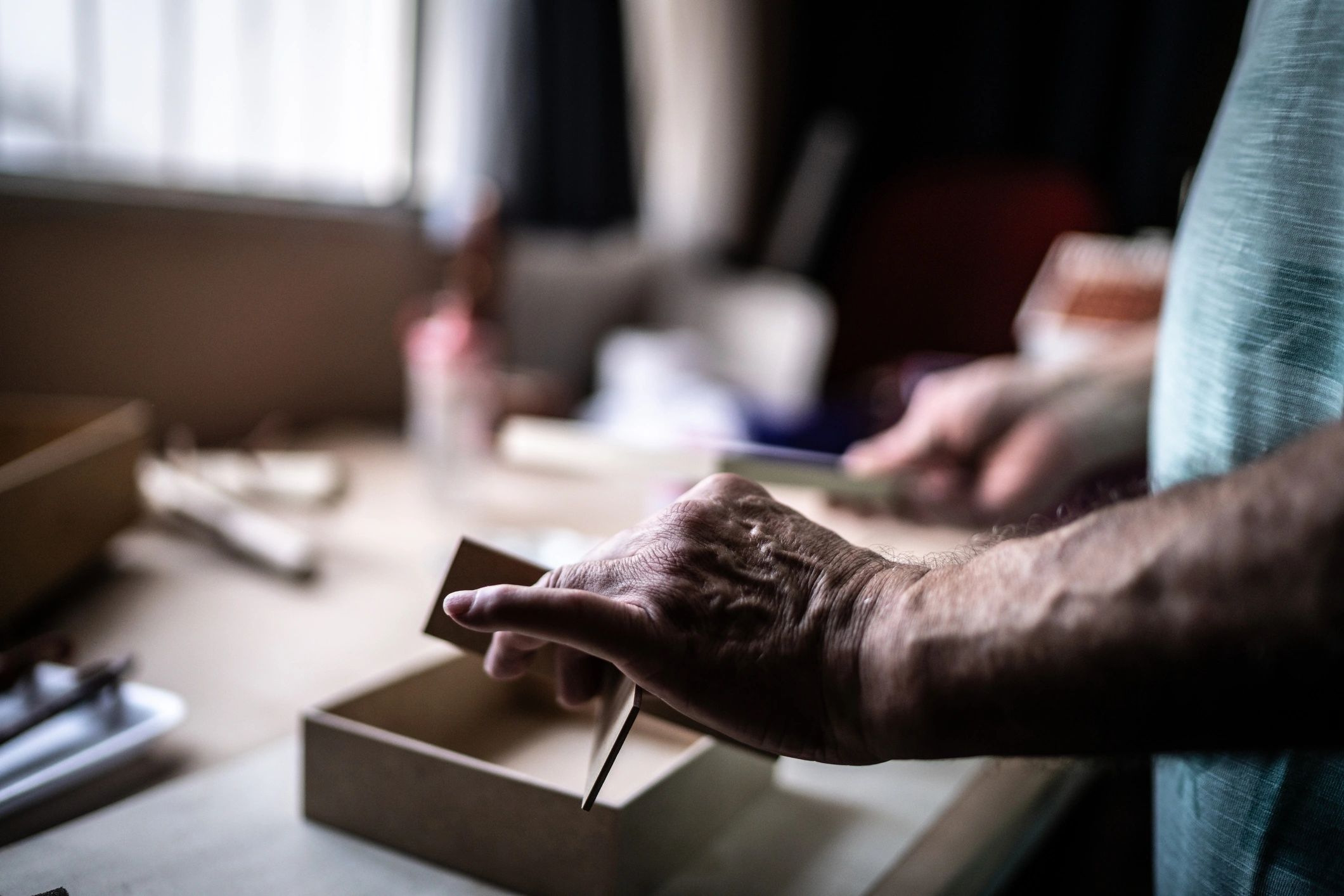 Close-up of artisan hands working on a handcrafted object