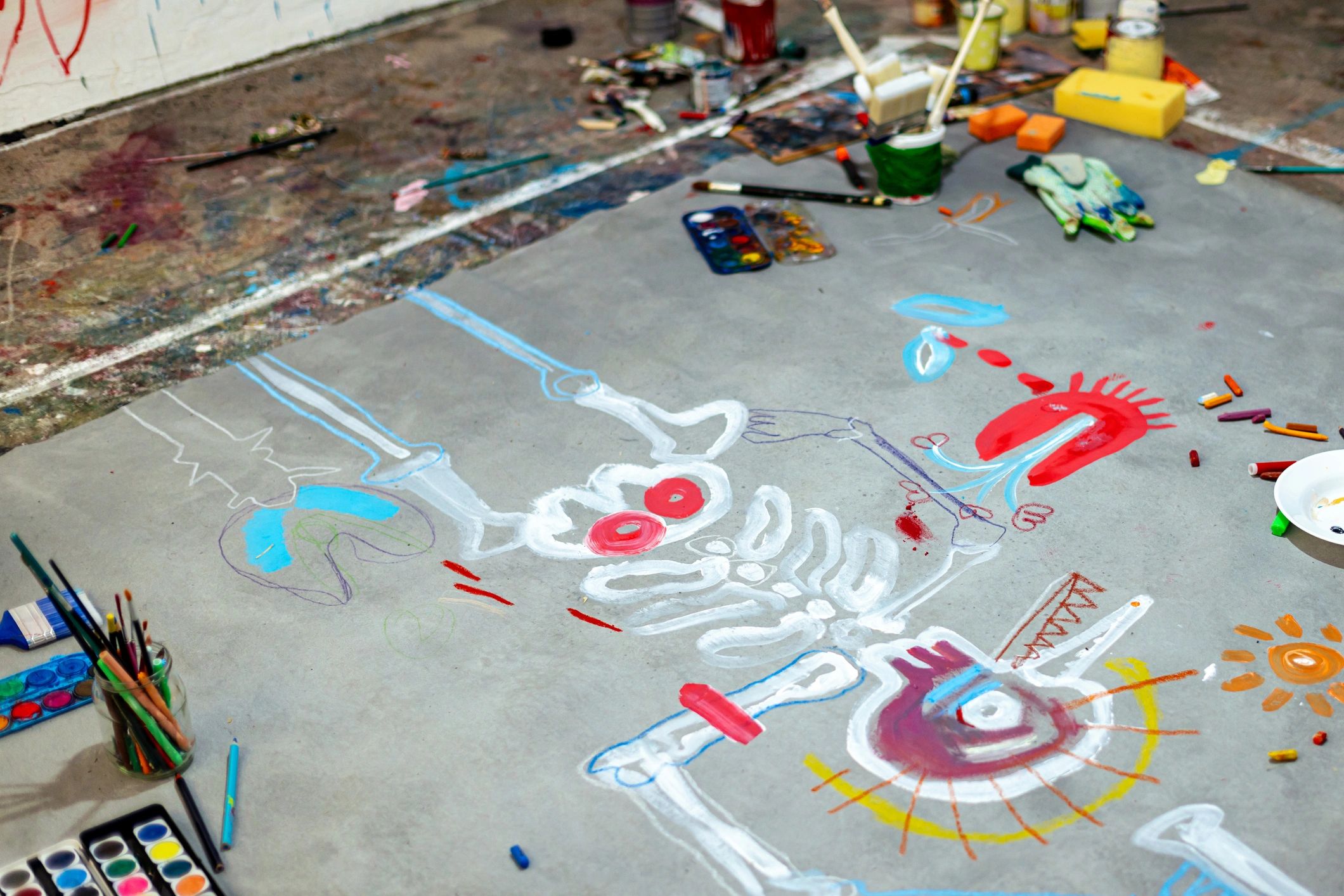 Artist studio floor with large abstract artwork in progress